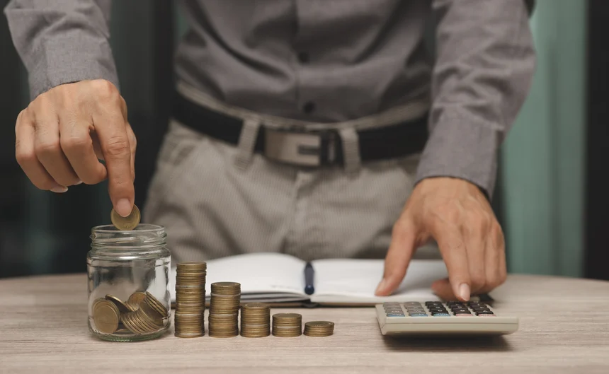 Man putting change in jar